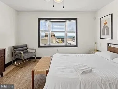 a bathroom with a bathtub and next to a window
