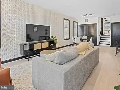 a bedroom with a bed a mirror on desk and chair