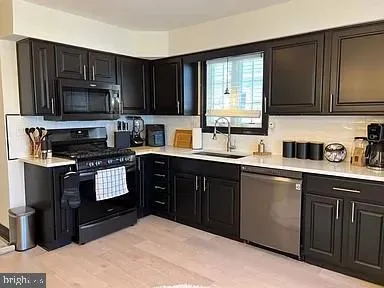 a kitchen with a sink stove and microwave