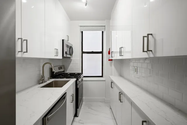 a kitchen with a sink cabinets and appliances