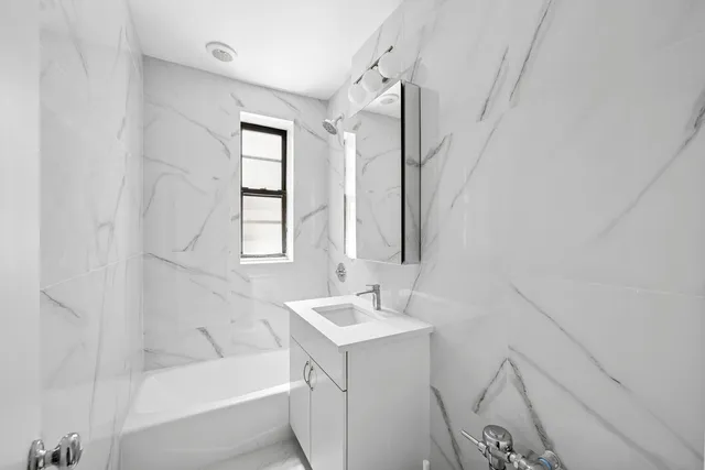 a bathroom with a bathtub a sink a vanity and a shower