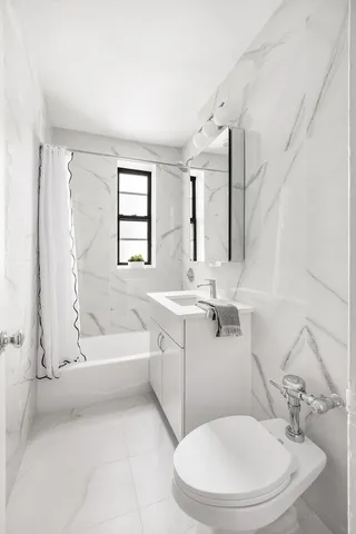 a bathroom with a sink a toilet and bathtub