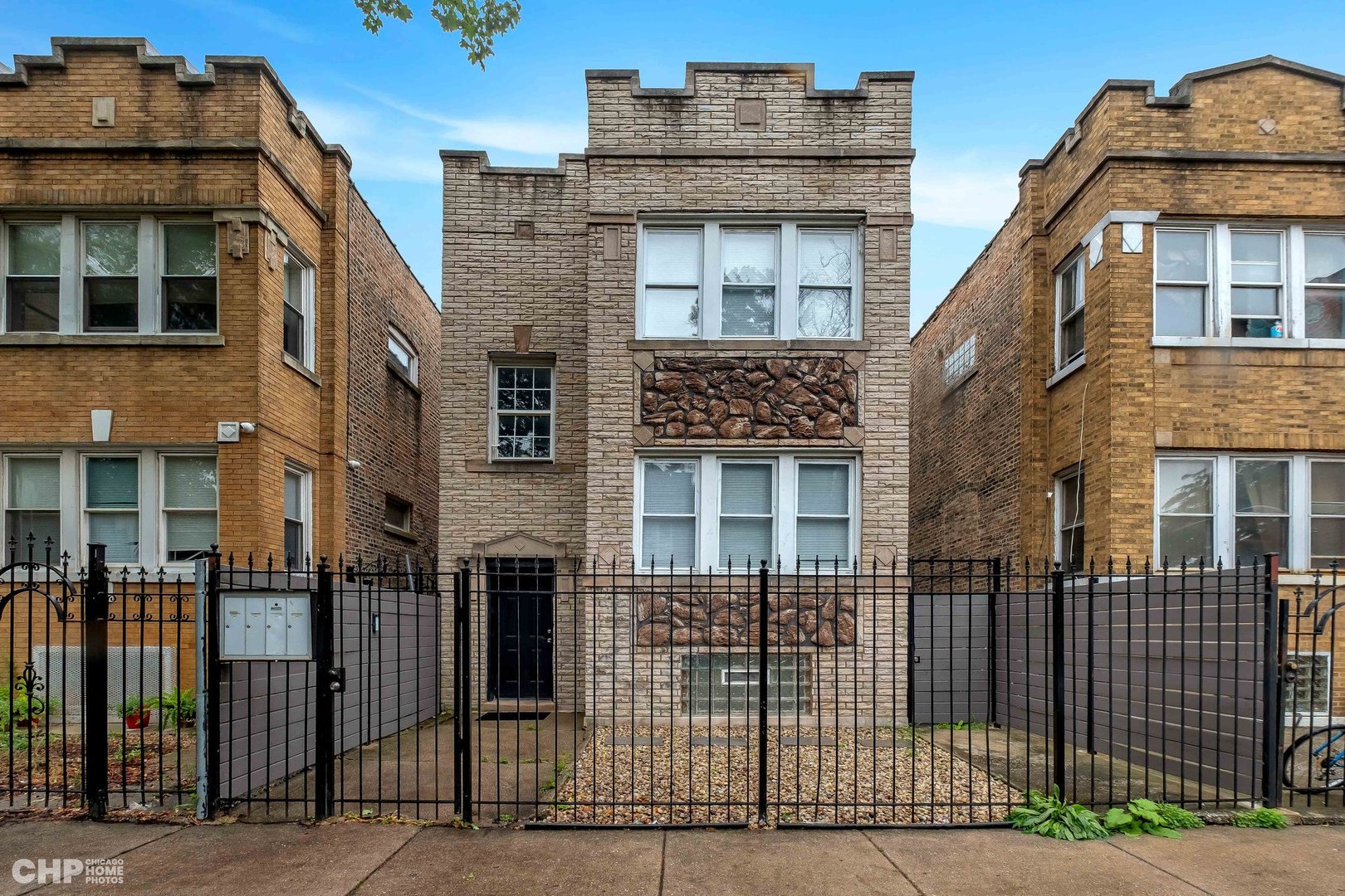 a front view of a house with iron fence