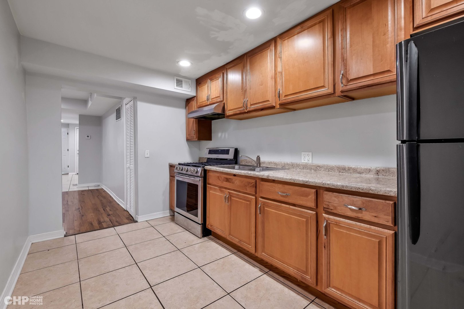 1052 North Springfield Avenue Chicago, IL 60651 - Photo 11 of 31 a kitchen with stainless steel appliances granite countertop a refrigerator and a sink