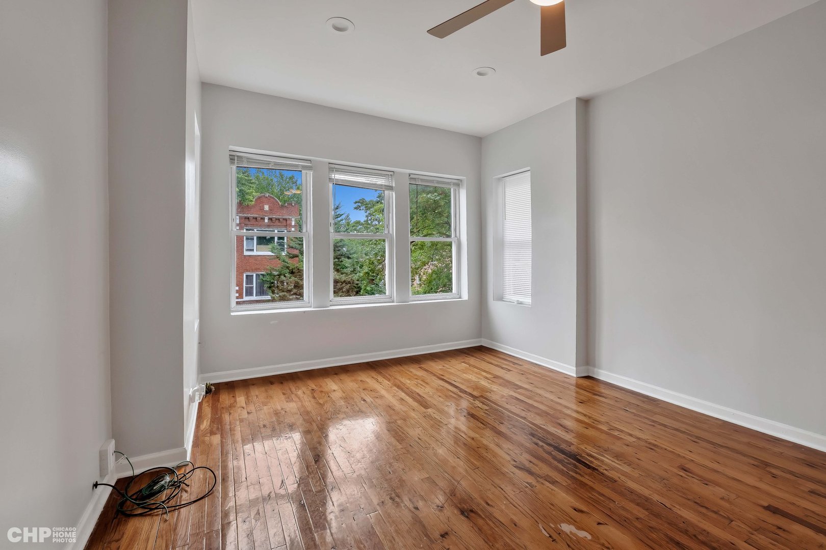 1052 North Springfield Avenue Chicago, IL 60651 - Photo 20 of 31 an empty room with wooden floor cabinet and windows
