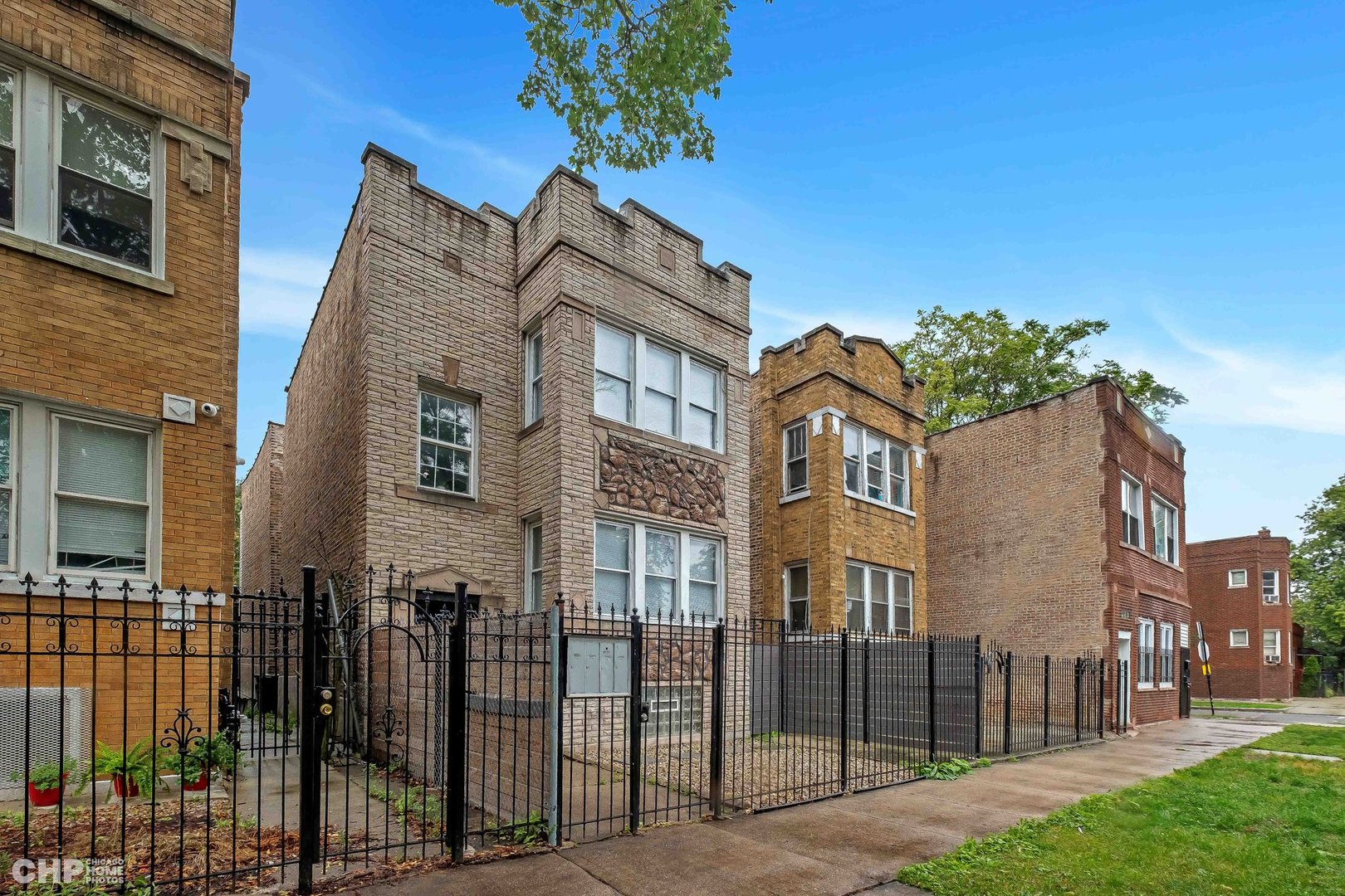 1052 North Springfield Avenue Chicago, IL 60651 - Photo 2 of 31 a front view of a house with a garden