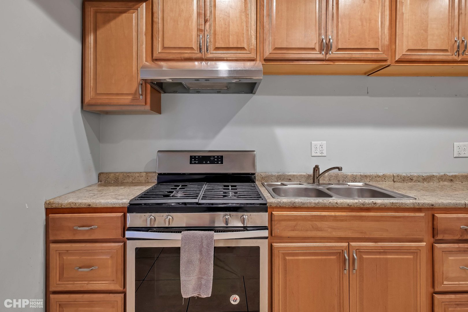 1052 North Springfield Avenue Chicago, IL 60651 - Photo 21 of 31 a kitchen with granite countertop cabinets appliances and a window