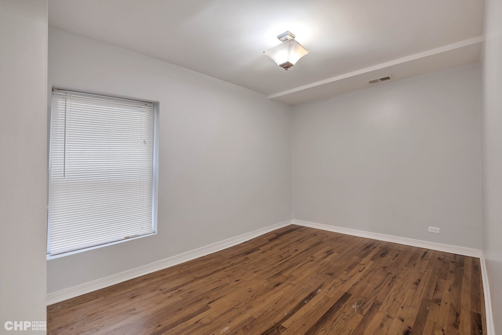 1052 North Springfield Avenue Chicago, IL 60651 - Photo 22 of 31 a view of a room with wooden floor and a window