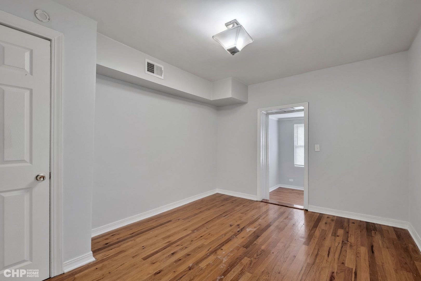 1052 North Springfield Avenue Chicago, IL 60651 - Photo 25 of 31 a view of empty room with wooden floor