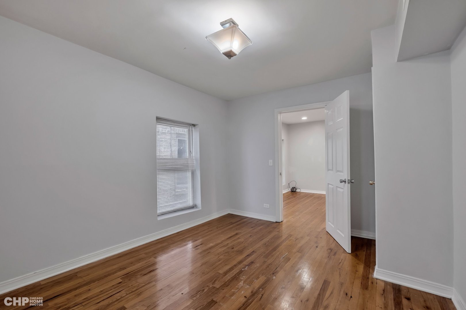 1052 North Springfield Avenue Chicago, IL 60651 - Photo 27 of 31 a view of empty room with wooden floor