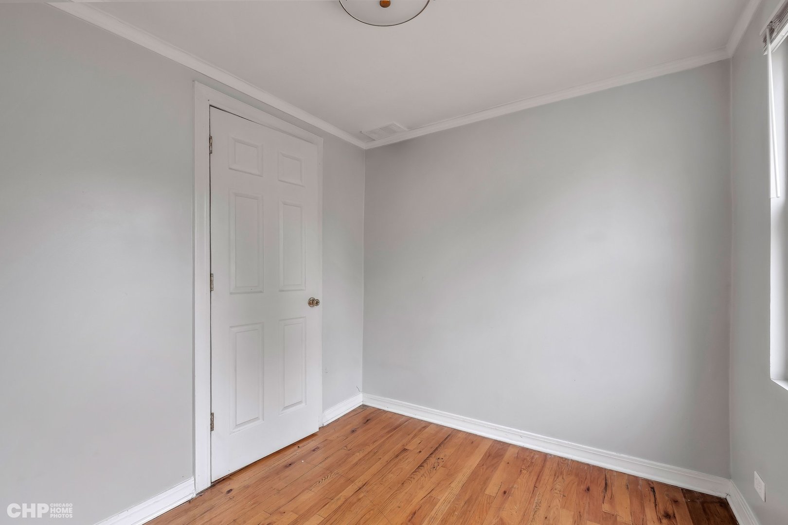 1052 North Springfield Avenue Chicago, IL 60651 - Photo 28 of 31 a view of a room with wooden floor