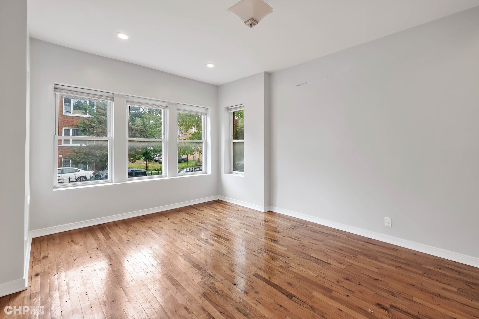 1052 North Springfield Avenue Chicago, IL 60651 - Photo 7 of 31 a view of an empty room with wooden floor and a window