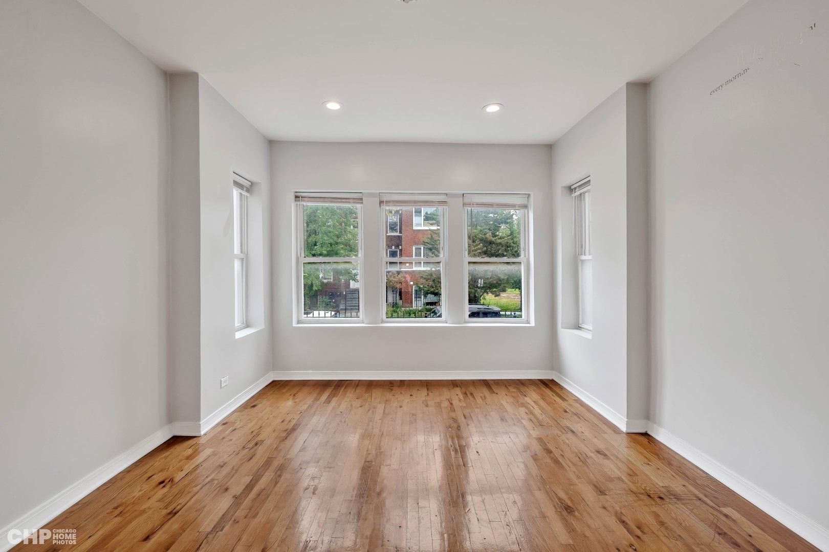 1052 North Springfield Avenue Chicago, IL 60651 - Photo 8 of 31 a view of an empty room with wooden floor and a window