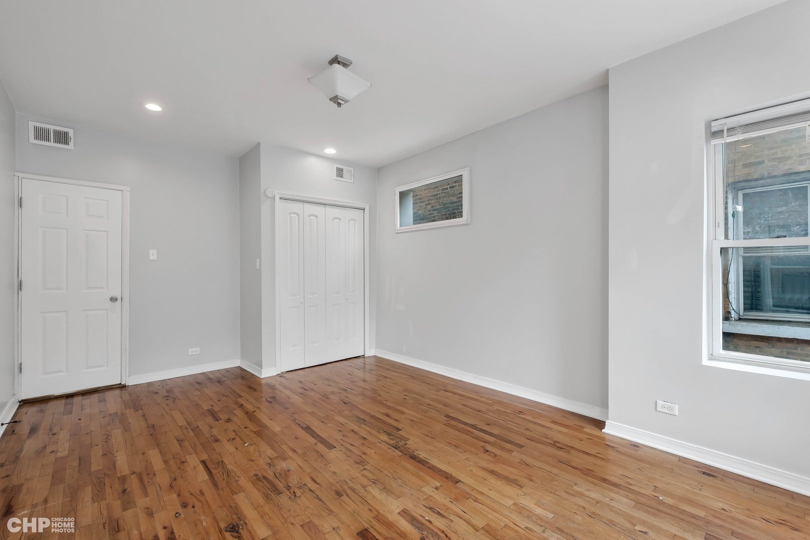 1052 North Springfield Avenue Chicago, IL 60651 - Photo 9 of 31 a view of empty room with wooden floor and fan