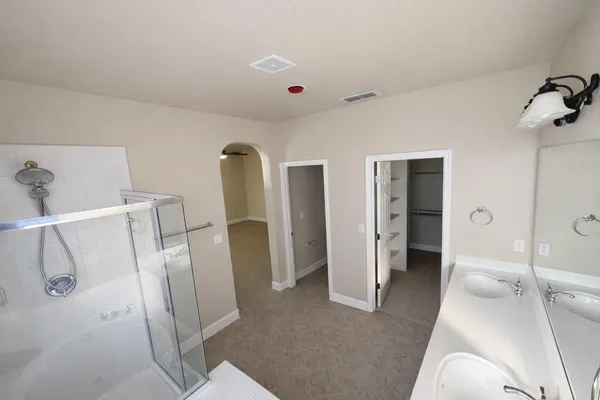 a view of walk in closet with empty racks