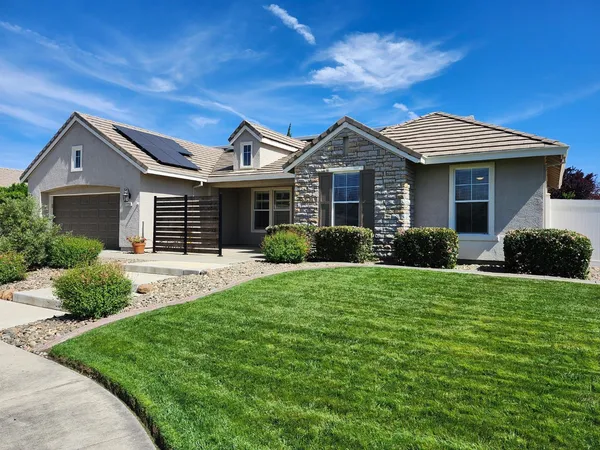 a front view of a house with a yard and porch