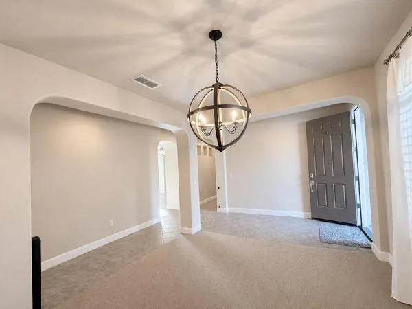 a view of a hallway with wooden floor and window