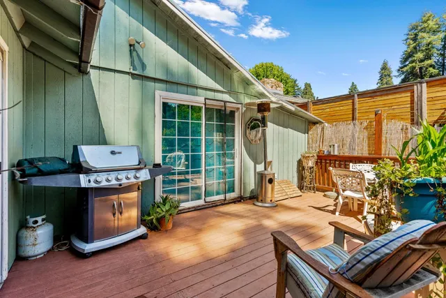 a view of house with a deck and furniture