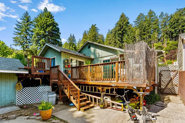 a view of a house with backyard water fountain and sitting area