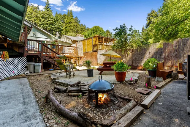 a view of a patio with table and chairs under an umbrella
