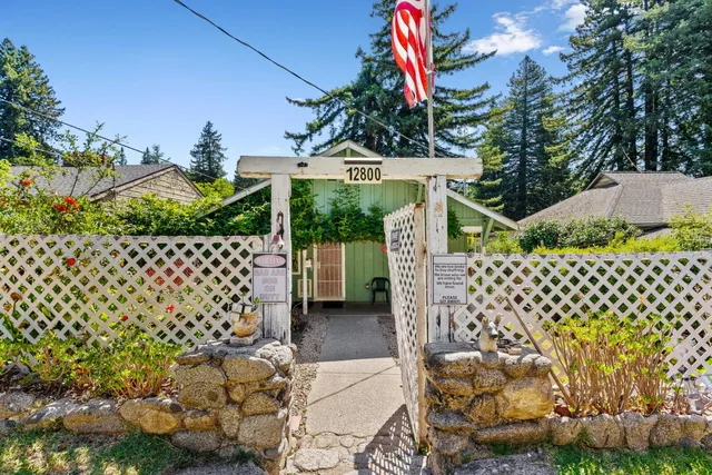 a view of a chair and table in backyard of the house