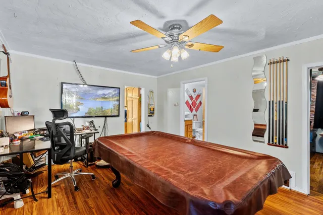 a view of a dining room with furniture and wooden floor