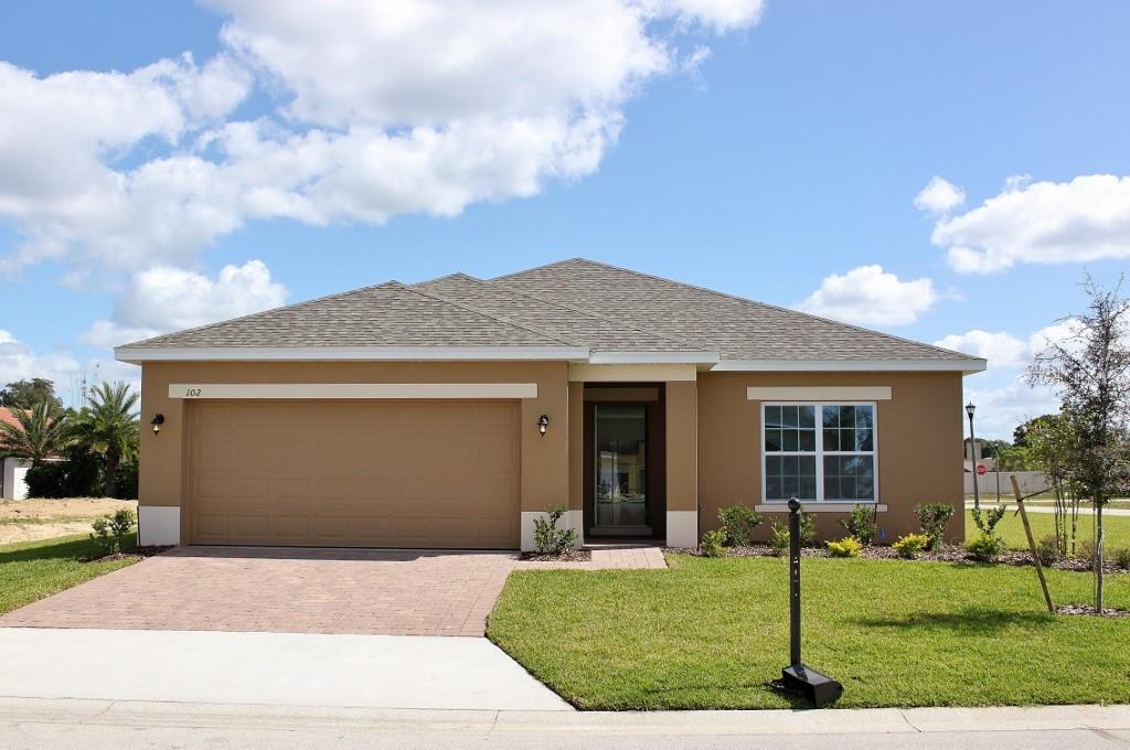 521 Vitoria Road Davenport, FL 33837 - Photo 1 of 1 a front view of a house with a yard and garage