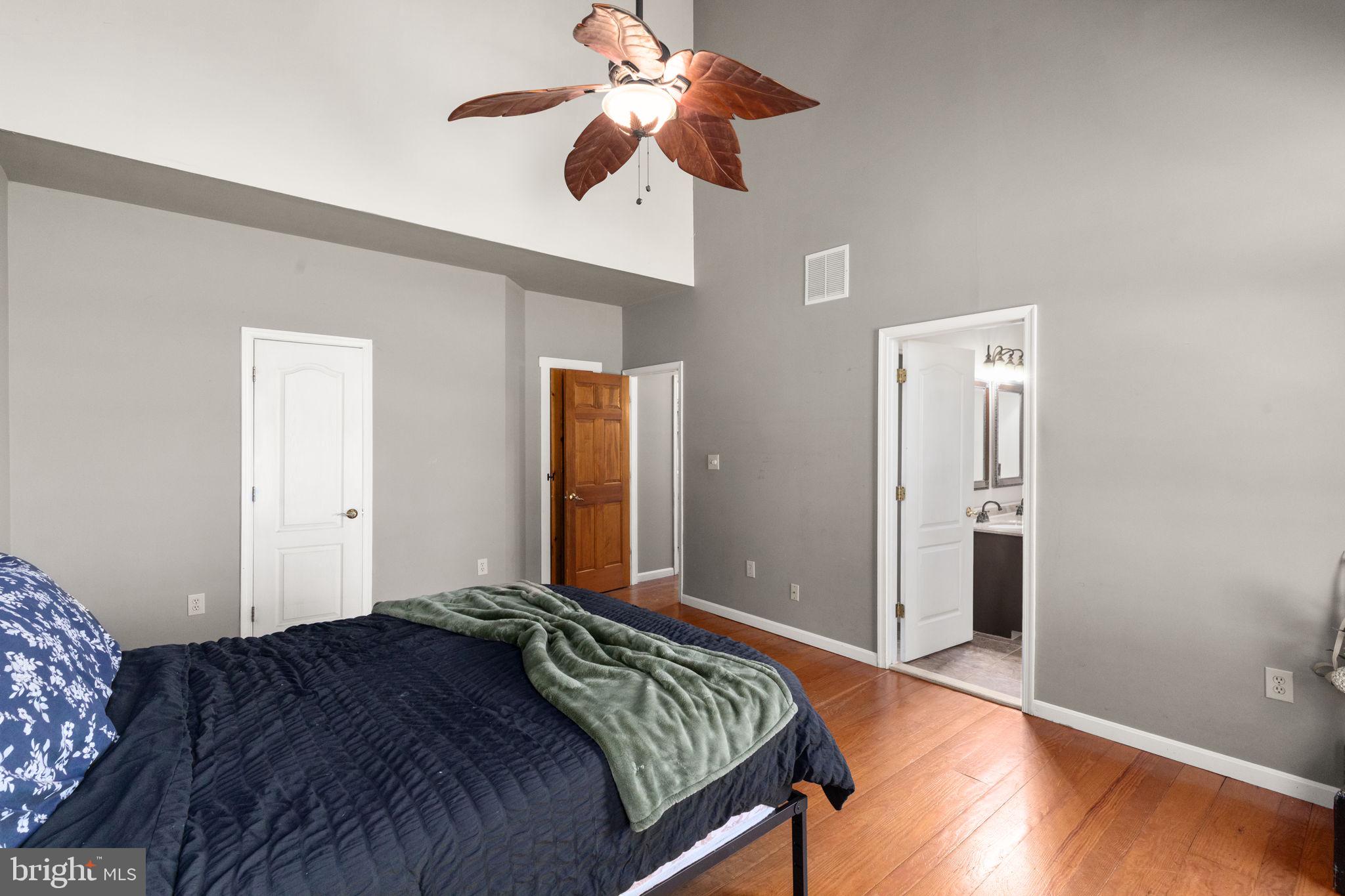 2140 Marston Road New Windsor, MD 21776 - Photo 19 of 48 a bedroom with a large bed and a chandelier fan