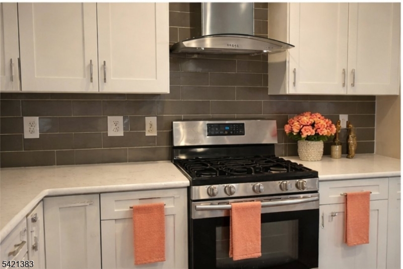 Undisclosed Address Edison, NJ 08820 - Photo 15 of 44 a kitchen with stainless steel appliances granite countertop a stove and a microwave