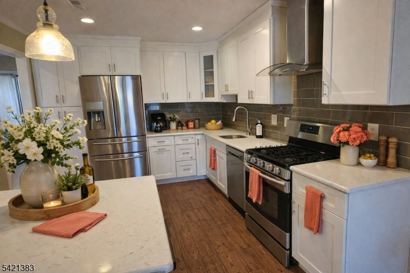 Undisclosed Address Edison, NJ 08820 - Photo 16 of 44 a kitchen with stainless steel appliances granite countertop a refrigerator a stove a sink dishwasher and a refrigerator with wooden floor