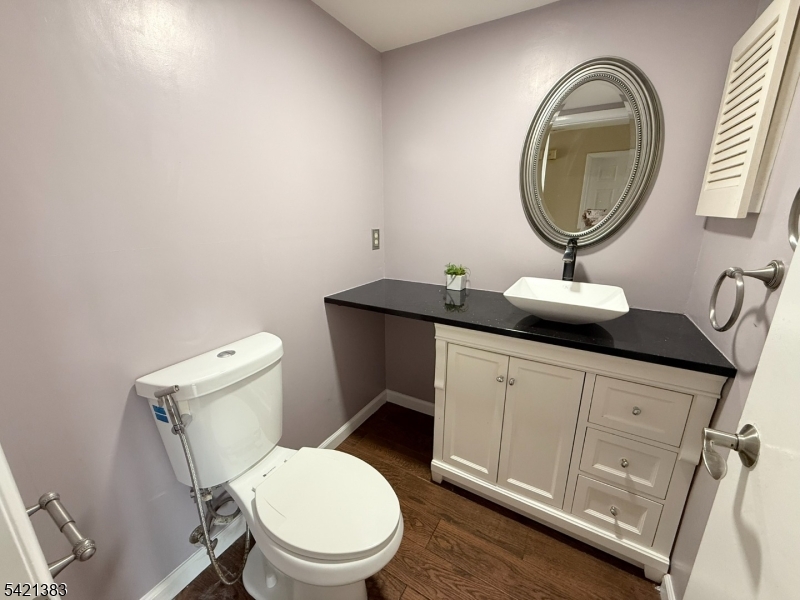 Undisclosed Address Edison, NJ 08820 - Photo 23 of 44 a bathroom with a toilet a sink and a mirror