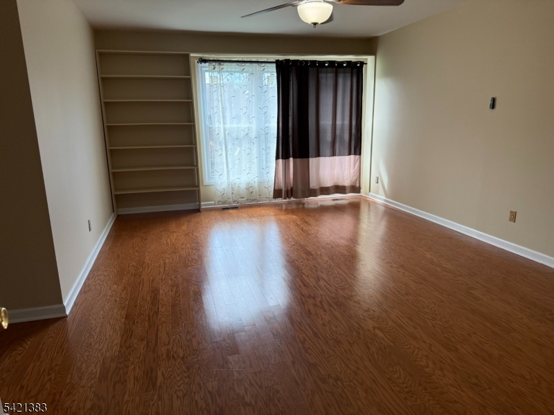 Undisclosed Address Edison, NJ 08820 - Photo 25 of 44 an empty room with wooden floor and windows