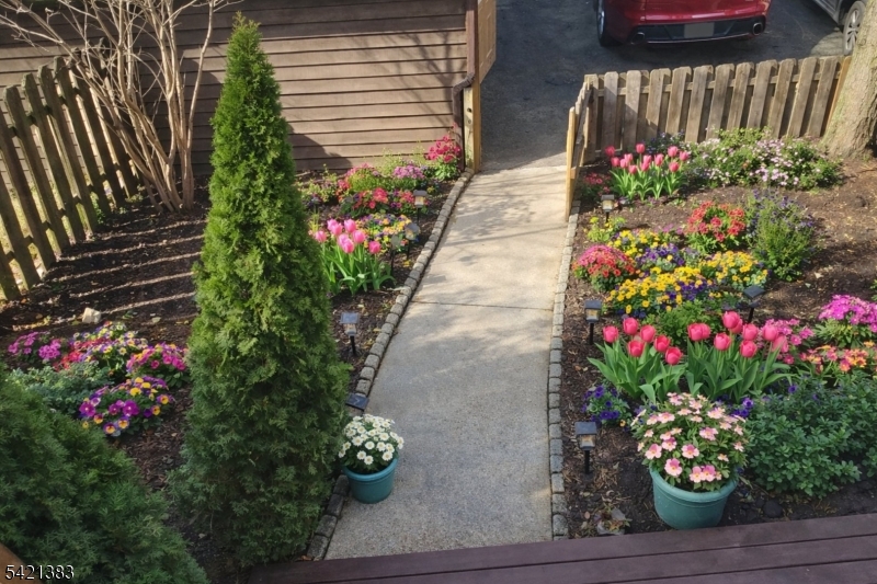 Undisclosed Address Edison, NJ 08820 - Photo 3 of 44 a bunch of flowers are in front of a house