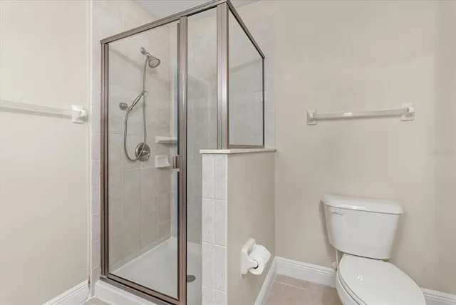 a bathroom with a toilet and a shower