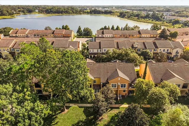 an aerial view of a house with outdoor space and lake view