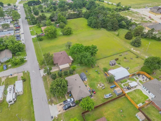 an aerial view of residential houses with outdoor space and swimming pool
