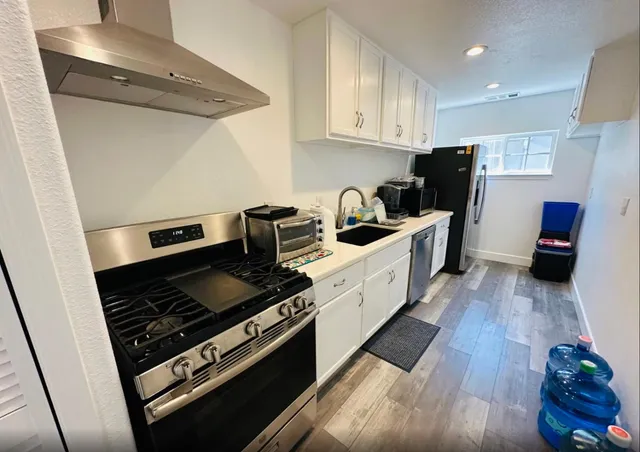 a kitchen with a stove and a refrigerator