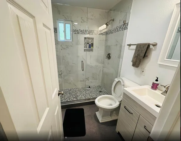 a bathroom with a sink toilet and shower
