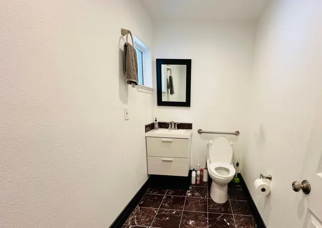 a bathroom with a sink toilet and vanity