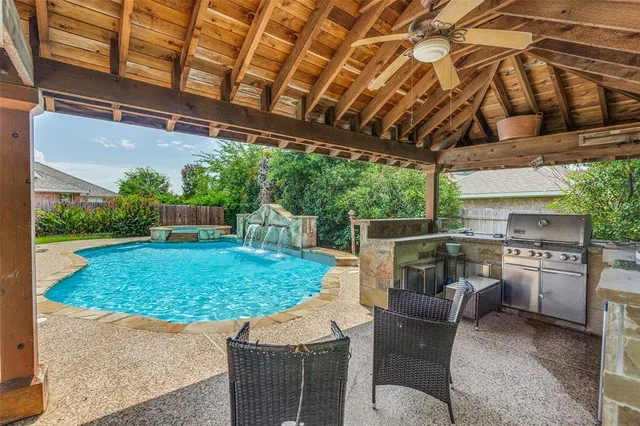 a view of a backyard with plants and a patio