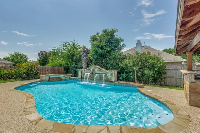 a view of a backyard with plants and a garden