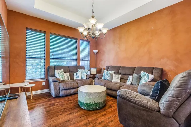 a living room with furniture and a chandelier