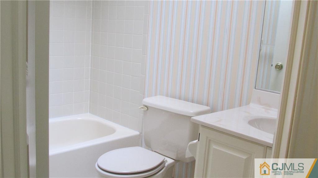 2407 Timber Oaks Road, Unit 2407 Edison, NJ 08820 - Photo 11 of 12 a bathroom with a sink a toilet and bathtub