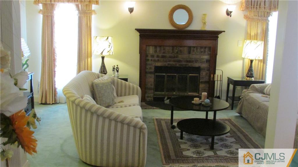 2407 Timber Oaks Road, Unit 2407 Edison, NJ 08820 - Photo 3 of 12 a living room with furniture and a fireplace