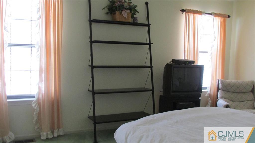 2407 Timber Oaks Road, Unit 2407 Edison, NJ 08820 - Photo 7 of 12 a bedroom with a bed and a window