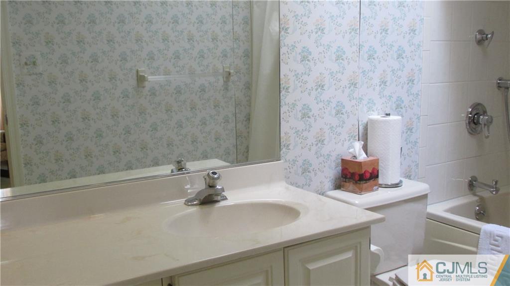 2407 Timber Oaks Road, Unit 2407 Edison, NJ 08820 - Photo 9 of 12 a bathroom with a sink and a mirror