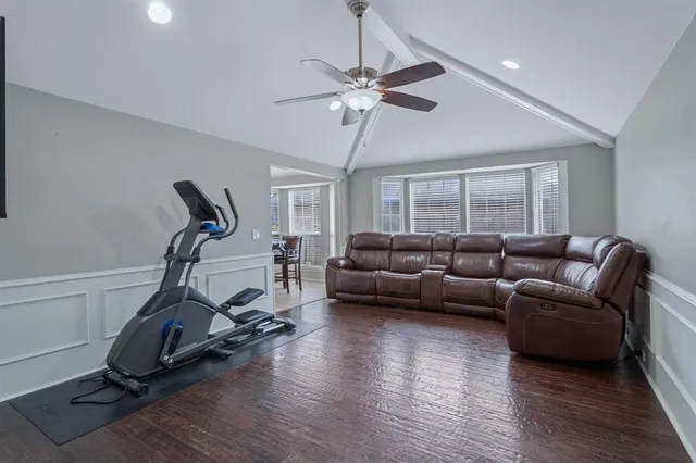 a living room with furniture gym equipment and a window