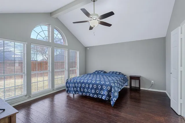 a living room with a bed furniture and a large window