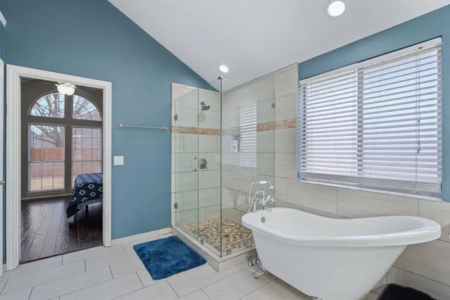 a bathroom with a bathtub and a shower