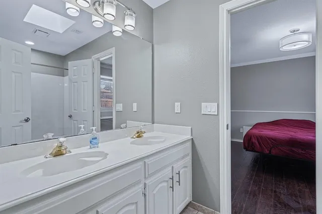 a bathroom with a sink double vanity and a mirror